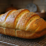 Freshly baked ultimate cabbage bread loaf cooling on a rack.