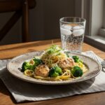 Final presentation of Chicken and Broccoli Pasta garnished with cheese on a rustic table, showcasing the delicious dish.