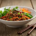 Final presentation of a Korean ground beef bowl, artfully displayed with flavorful ingredients and garnishes, perfect for a hearty meal.